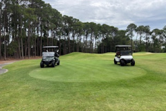 Sponsors-carts-positioned-on-the-9th-tee-at-The-Pines-golf-course-