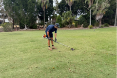 Trimming-irrigation-sprinkler-heads-on-The-Palms-golf-course