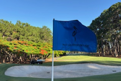 Legends-Pro-Am-flag-placed-on-the-1st-green-on-The-Pines-golf-course