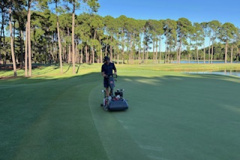 Walk-mowing-the-perimeter-of-the-10th-green-on-The-Pines-golf-course-for-the-Legends-Pro-Am-