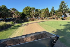 Topdressing-around-the-small-practice-putting-green-at-The-Pines-golf-course